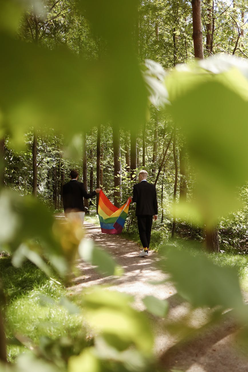 a couple holding a rainbow flag