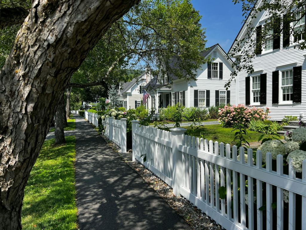 charming new england street with white picket fence