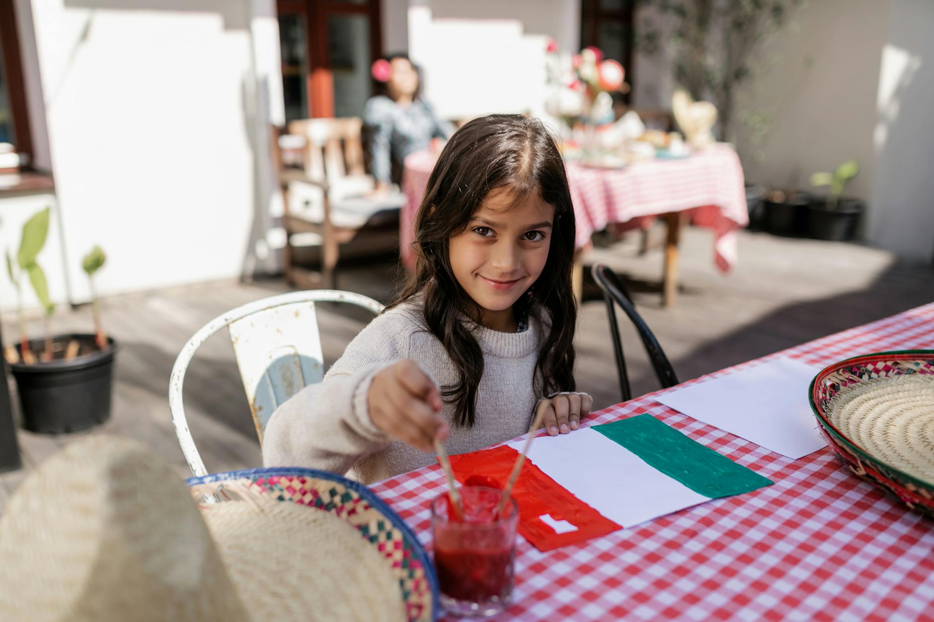 cute girl painting mexican flag on paper