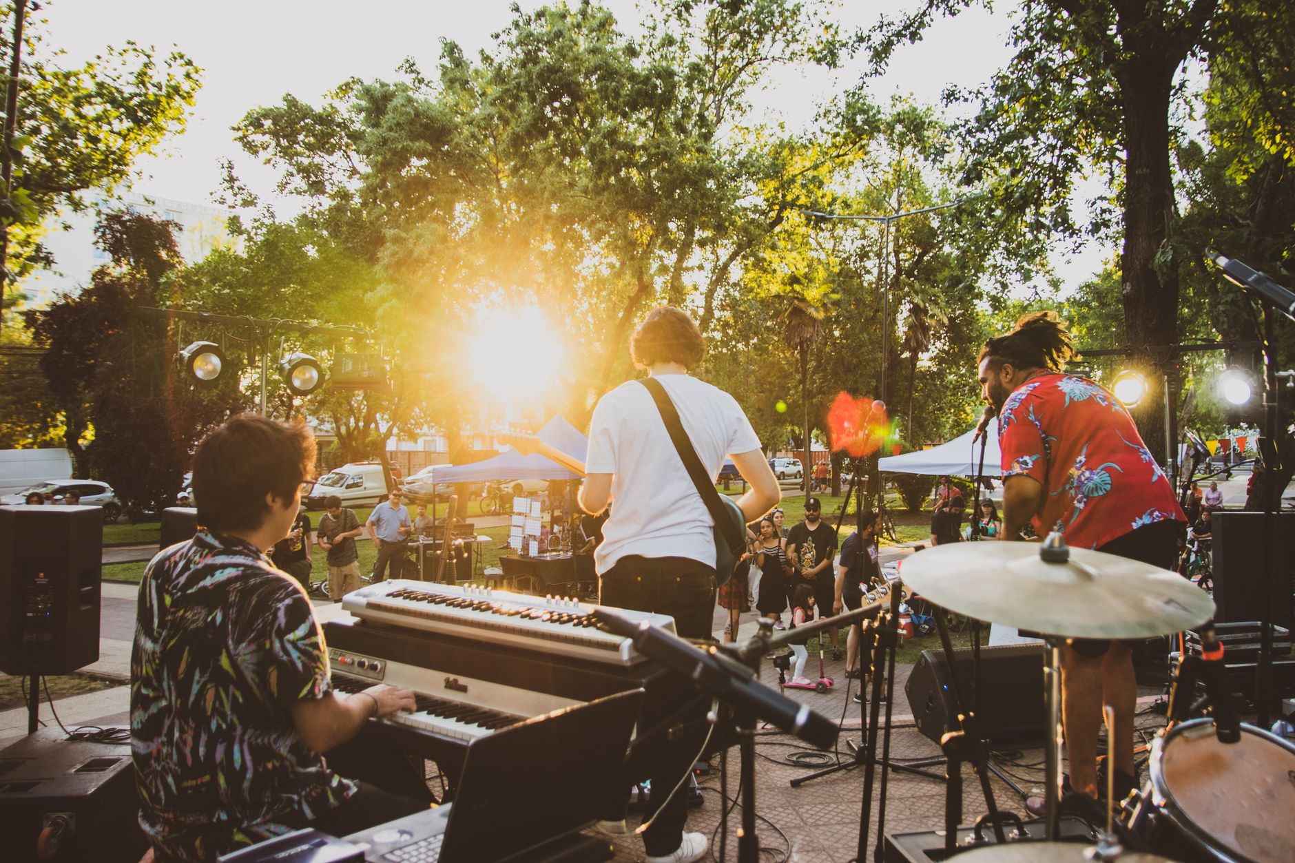 a band playing music in a park in summer