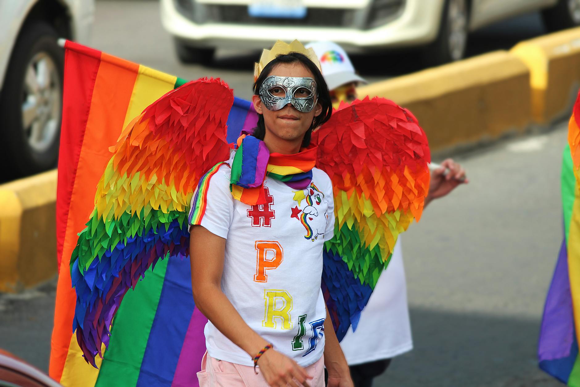 man wearing rainbow costume on a parade