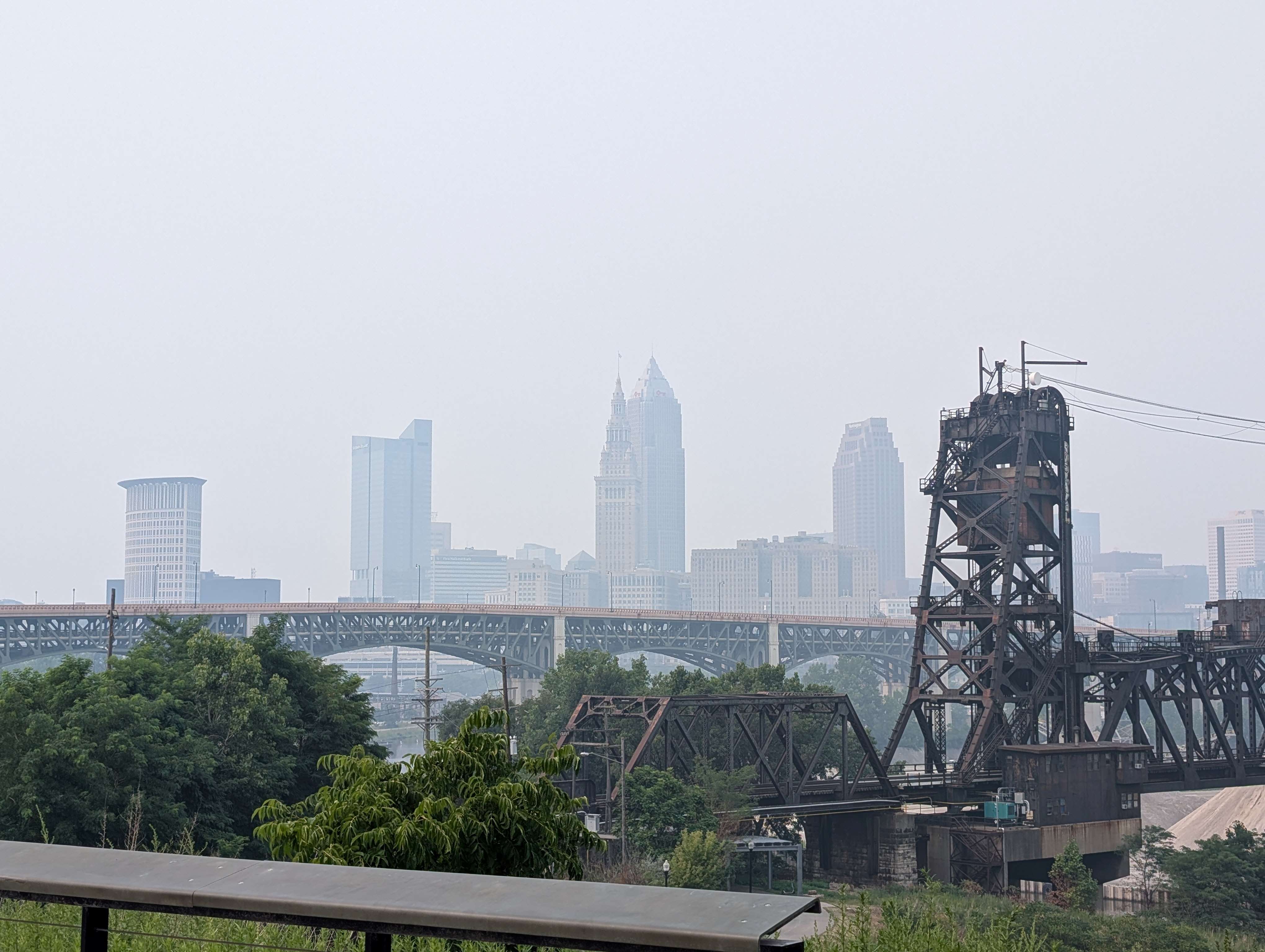 Skyline of Cleveland, Ohio, with skyscrapers and a bridge in the foreground.