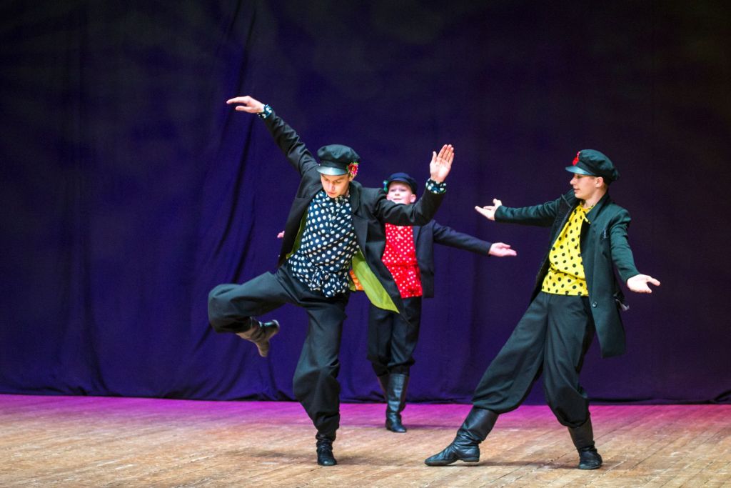 photograph of boys dancing on a stage