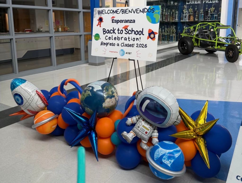A colorful display of space-themed decorations and a welcome sign for a "Back to School Celebration" event presented by AT&T.